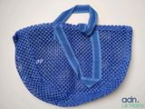 a close up of a blue shopping bag with a blue handle