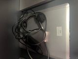 a laptop and headphones sitting on a shelf next to a mouse