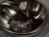 a close up of a washing machine with the door open