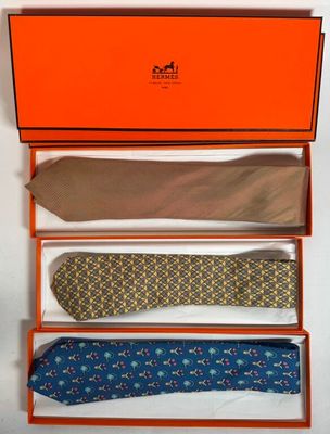 three ties in a box with a tie in the middle