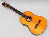 an image of a small acoustic guitar sitting on a white surface