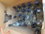 a cardboard box filled with bottles of water and a hand reaching for a bottle