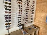 a display of sunglasses on a wall in a store