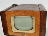 an old fashioned television sitting on a wooden stand