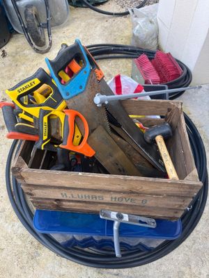 a wooden box with tools in it on the ground