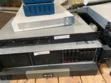a stack of computer equipment sitting on top of a table
