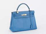 a blue leather handbag on a white background