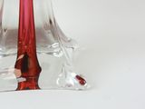 a glass vase with a red candle inside of it