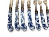 five forks and five knives with blue and white designs on them