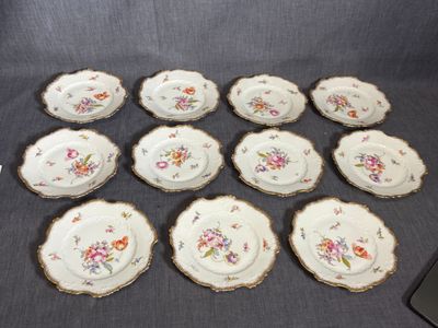 six plates with floral designs on them sitting on a table