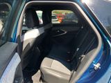 a blue car with the back seats folded down