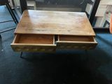 a wooden table with two drawers on it