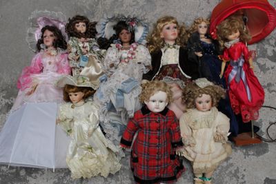 a lot of dolls that are sitting on the ground