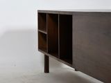 an image of a wooden sideboard in a white room