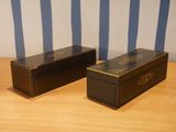 two boxes that are sitting on a wooden table