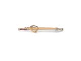 a close up of a gold and diamond arrow broochle