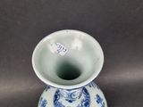a blue and white vase sitting on a table
