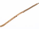 a close up of a gold bracelet on a white background