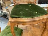 a wooden chair with a green cushion on top of it