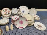 a lot of plates and bowls on the table