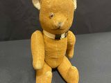 a yellow teddy bear that is sitting on a table