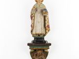 a wooden statue of a woman with a crown on a pedestal