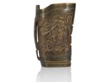 an old bronze pitcher with a dragon design on the handle