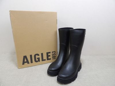 an image of a pair of black rain boots next to a box