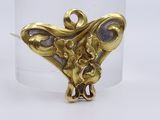 an image of a close up of a gold plated object on a white surface