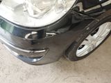a picture of a car that has been dented and is in a garage
