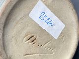 a close up of a vase with a label on it