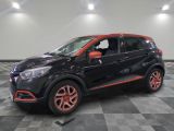 a black and orange car parked on a checkered floor