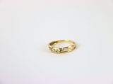 a close up of a wedding ring on a white surface