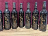 six bottles of wine sitting on top of a wooden table