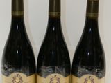 trois bouteilles de vin posées sur une table l'une à côté de l'autre