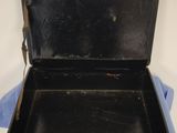 a black suitcase sitting on top of a blue cloth