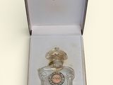 perfume bottle in a box on a table with a white background