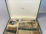 a green case filled with silverware and spoons on top of a table
