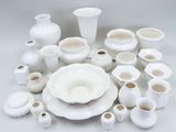 a lot of white vases and plates on the table