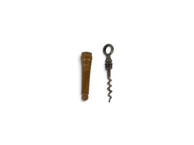 two corks and a cork opener on a white surface