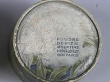 two tins that have flowers on them on a table