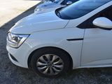 a white car parked in a parking lot with other cars in the background