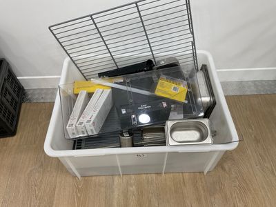a white container filled with electronic equipment on a wooden floor