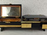 a black and gold jewelry box with a mirror on top of it