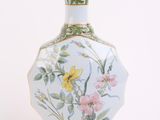 a white vase with a floral design on it
