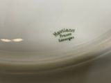 a close up of a white plate with a hawaiian fruit logo on it