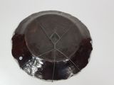 a silver plate with a diamond on it sitting on a table