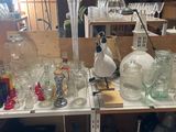 a lot of bottles and glasses on a shelf