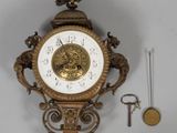 a clock that is hanging on the wall next to a key
