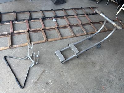 a picture of a metal bed frame and some tools on the floor